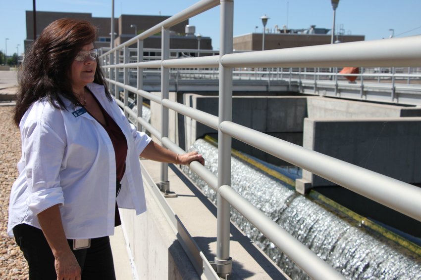 South Platte Water Renewal Partners outreach specialist Deb Parker watches the final stage of the wastewater treatment process, where cleaned water reenters the South Platte River. The plant needs millions of dollars in upgrades in coming years to fulfill state mandates.